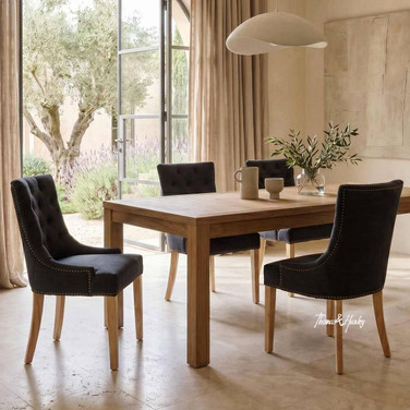 Thomas and Hurley Braddock Dining Chair in Black with Natural Leg styled in a light-filled dining space with elegant contemporary classic décor.