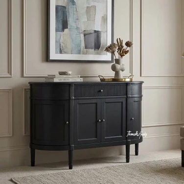 The Louis Buffet 4 Door 130cm in Black by Thomas and Hurley, front angle view and closed position, showcasing its curved design, fluted drawer detailing, and functional storage.