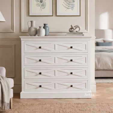 Elegant white storage chest featuring X-pattern drawer fronts.