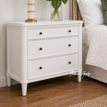 A spacious white three drawer Hamptons or modern styled bedroom table.