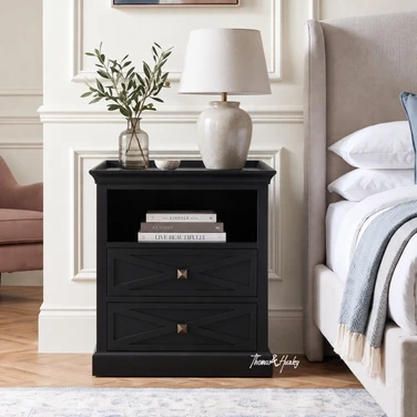 Elegant black storage nightstand featuring geometric drawer fronts and an open cubby.