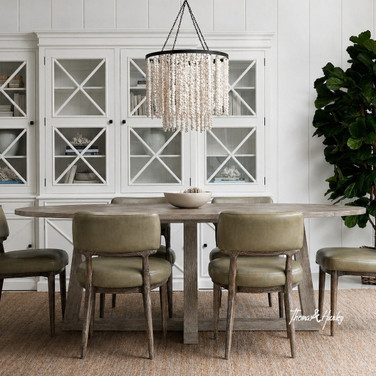 Ovalis 280cm Dining Table in brushed oak styled in a spacious dining room with leather chairs
