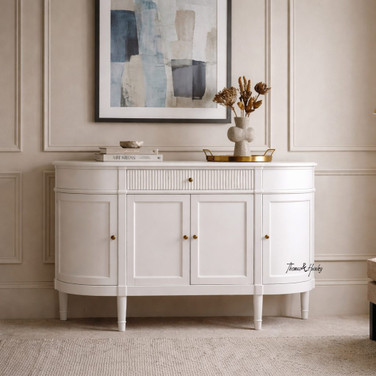 The Louis Buffet 4 Door 130cm in White by Thomas and Hurley, front view, styled and closed position, showcasing its curved design, fluted drawer detailing, and functional storage.