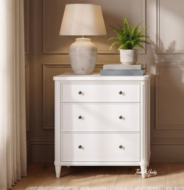 White Brynmore 3 Drawer Petite Bedside by Thomas and Hurley styled with a ceramic table lamp and potted fern.