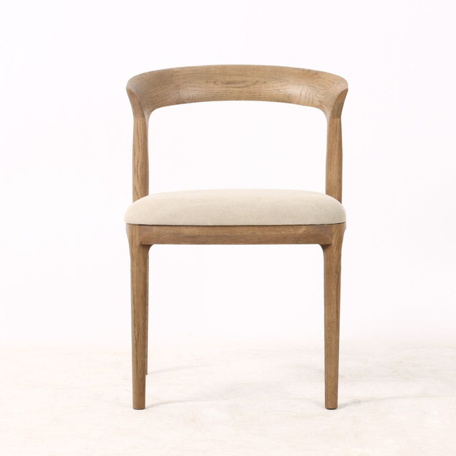 Laguna Dining Chair in natural timber finish, front view highlighting sculptural backrest and premium upholstered seat — luxury contemporary dining chair for modern Hamptons interiors.