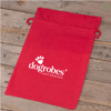 Red Dogrobes drawstring bag with printed white logo flat on wooden surface