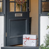 Dogrobes grey gift box with red printed ribbon on doorstep with wreath