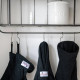 Pet Remedy Mini Calming Spray on shelf. Dogrobes' black dog drying mitts, towelling robe for dogs, and dog Snood hanging from hooks under the shelf.