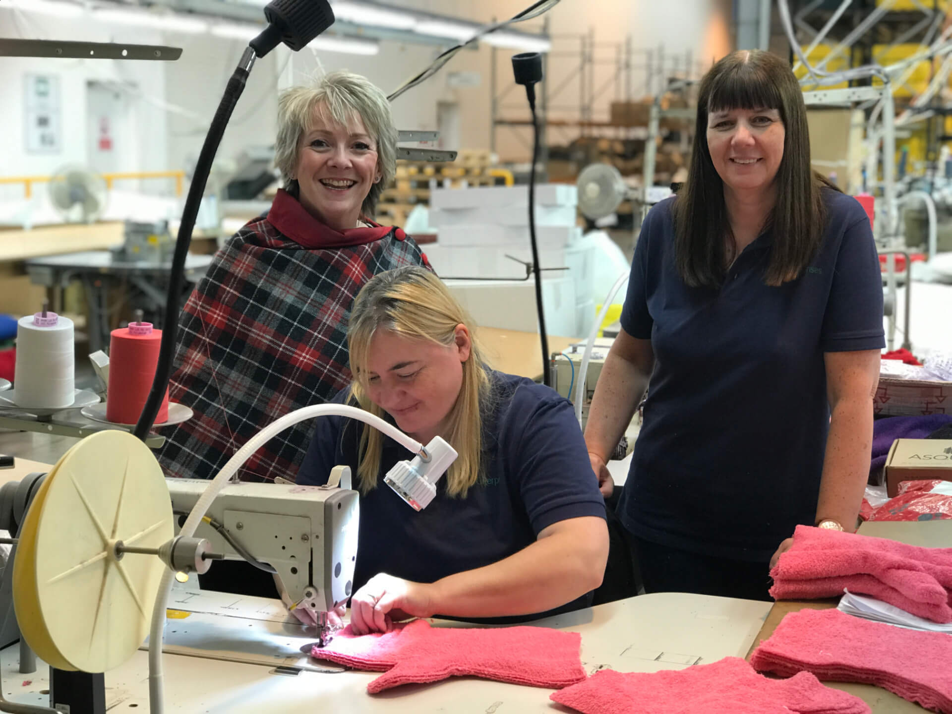Margaret from Dogrobes with the sewing team in a British workshop, proudly crafting Dogrobes products