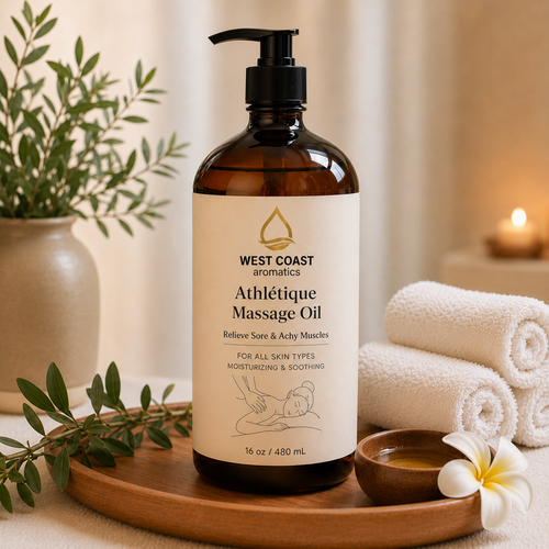 Athlétique Massage Oil 16 oz amber pump bottle by West Coast Aromatics with spa towels, candle, and relaxing wellness setting for sore and achy muscle relief.