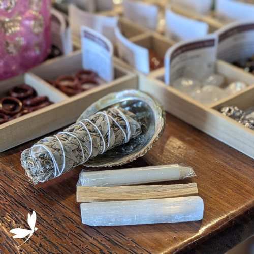 White Sage Cleansing Kit with abalone shell, white sage bundle, selenite stick, white candle, and palo santo displayed on a wooden surface — spiritual smudge set from Prana Blessings Metaphysical Shop in Santa Fe. White Sage Cleansing Kit with abalone shell, white sage bundle, selenite stick, white candle, and palo santo displayed on a wooden surface — spiritual smudge set from Prana Blessings Metaphysical Shop in Santa Fe.