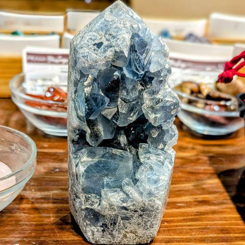 Celestite cluster tower - beautiful blue color on a table.