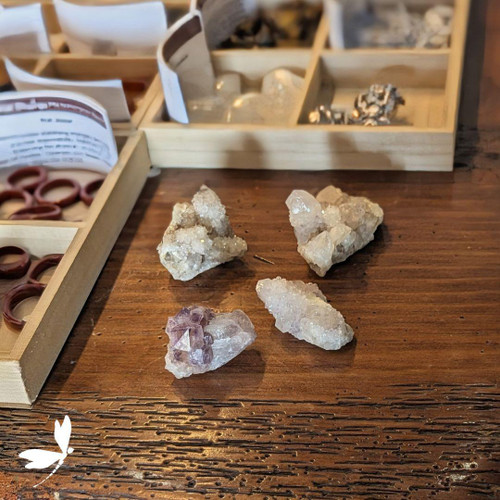 Amethyst Spirit Quartz cluster with sparkling lavender points displayed on a wooden surface at Prana Blessings Metaphysical Shop — crystal for creativity, balance, and harmony. Amethyst Spirit Quartz cluster with sparkling lavender points displayed on a wooden surface at Prana Blessings Metaphysical Shop — crystal for creativity, balance, and harmony.