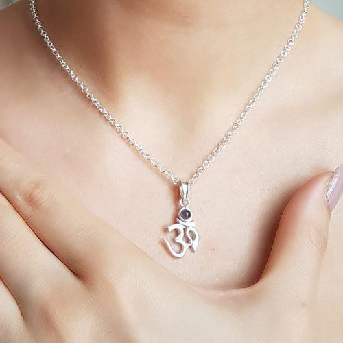 Close-up of sterling silver Ohm pendant with natural Iolite gemstone by Crystal Earth Studios, symbolizing intuition and divine alignment. Close-up of sterling silver Ohm pendant with natural Iolite gemstone by Crystal Earth Studios, symbolizing intuition and divine alignment.