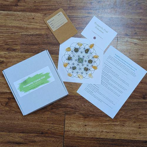 Prosperity Crystal Grid guided ritual kit with crystals, Flower of Life grid, intention journal, activation card, and instructions
