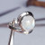 Sterling silver Endless Life ring with rainbow moonstone, handcrafted by Crystal Earth Studios, size 9 artisan jewelry. Sterling silver Endless Life ring with rainbow moonstone, handcrafted by Crystal Earth Studios, size 9 artisan jewelry.