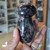 Polished Rhodonite Mushroom approximately 3 inches tall with pink and black patterns, held by hand inside Prana Blessings Metaphysical Shop in Santa Fe — heart chakra crystal for emotional healing and self-love.