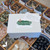 Closed Self-Love Mystery Box from Prana Blessings Metaphysical Shop with green brushstroke label, white gift box, and affirmation card beside it. Closed Self-Love Mystery Box from Prana Blessings Metaphysical Shop with green brushstroke label, white gift box, and affirmation card beside it.