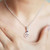 Close-up of sterling silver Ohm pendant with natural Iolite gemstone by Crystal Earth Studios, symbolizing intuition and divine alignment. Close-up of sterling silver Ohm pendant with natural Iolite gemstone by Crystal Earth Studios, symbolizing intuition and divine alignment.