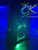 Black Xbox 360 Slim RGH3 with custom green LED lighting. Professionally built by ConsoleKings360.com.