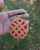 Front view of a handmade crochet cherry Pie mirrored keychain