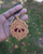 Front view of a handmade crochet ghoul berry Pie mirrored keychain