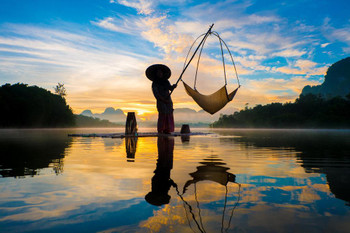 Fisherman On Raft With Fishing Nets In Asia Sky Reflecting On Lake