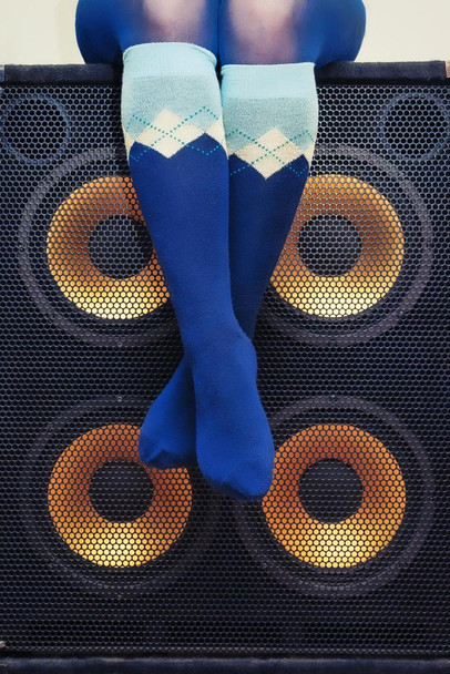 Laminated Woman in Blue Argyle Socks Sitting on Bass Speakers Rock Roll Music Poster Dry Erase Sign 12x18