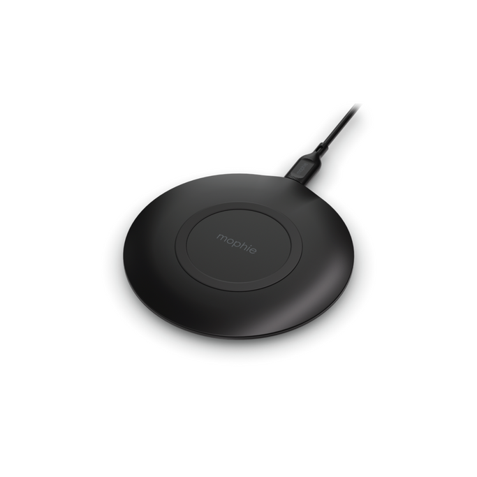 Smartphone placed on 15W charging pad with charging indicator illuminated