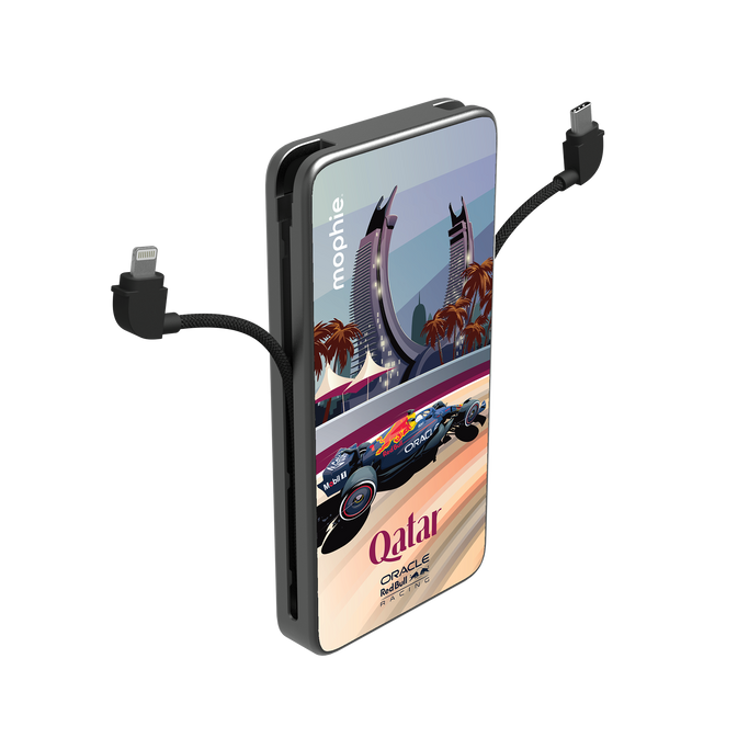 The sleek black Powerstation Plus 10K on a marble desk in a Doha high-rise, its integrated Lightning cable charging an iPhone next to a cup of traditional Qahwa.