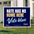 A yard sign which reads, "hate has no home here, vote blue"