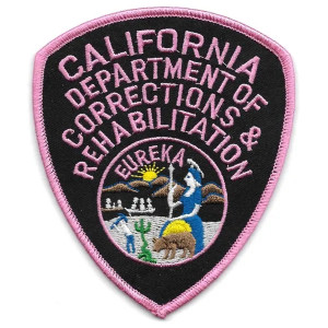 Close-up of embroidered CDCR insignia with pink and black detailing Close-up of embroidered CDCR insignia with pink and black detailing