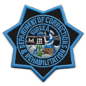 Close-up of embroidered CDCR blue star insignia Close-up of embroidered CDCR blue star insignia