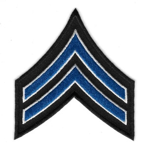 Close-up of embroidered Corporal Chevrons rank insignia