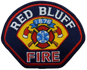 Close-up of embroidered Red Bluff Fire emblem and text