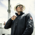 Man wearing men’s FR fleece zip-up jacket on job site in black color