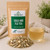 Organic Cold and Flu Tea in The Tea Hut certified organic kraft pouch, with loose ginger root, liquorice root, lemon myrtle and lemongrass beside a pale golden brewed cup.