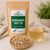 Organic Ashwagandha Root Tea in The Tea Hut certified organic kraft pouch, with loose chopped ashwagandha root beside a pale golden brewed cup.