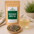 Silver Needle White Tea in The Tea Hut kraft pouch, with loose long silvery white tea buds beside a pale honey-yellow brewed cup.