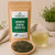 Organic Japanese Sencha Green Tea in The Tea Hut certified organic kraft pouch, with loose Japanese sencha leaves beside a pale green brewed cup.