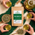Certified Organic Vibe Green Tea in The Tea Hut branded kraft pouch, with green tea, oat straw, Siberian ginseng, astragalus, lemon balm, ginkgo and cinnamon, plus cups of warm green-gold tea with a herbal-spice character.