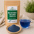 Organic Blue Butterfly Pea Flower Powder Tea in The Tea Hut certified organic kraft pouch, with loose blue butterfly pea flower powder beside a vivid blue brewed cup.