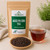Organic Aged Pu-erh Tea in The Tea Hut certified organic kraft pouch, with loose ripe aged Pu-erh leaves beside a deep reddish-brown brewed cup.