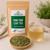Organic Paw Paw Leaf Tea in The Tea Hut certified organic kraft pouch, with loose paw paw leaves beside a pale golden brewed cup.