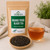 Bulk Orange Pekoe Black Tea (Ceylon) in The Tea Hut certified organic kraft pouch, with loose whole-leaf Ceylon black tea beside a clear amber brewed cup.