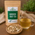 Bulk Burdock Root Tea in The Tea Hut certified organic kraft pouch, with loose chopped burdock root beside a golden brewed cup.