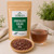 Bulk Chocolate Cacao Tea in The Tea Hut certified organic kraft pouch, with loose cacao husks beside a warm cocoa-brown brewed cup.
