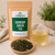 Bulk Soursop Green Tea in The Tea Hut kraft pouch, with a loose blend of organic green tea and organic soursop with natural flavour beside a pale golden-green brewed cup.