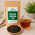 Russian Caravan Tea in The Tea Hut kraft pouch, with loose organic Assam, Keemun, Puerh and Lapsang Souchong beside a deep reddish-amber brewed cup.