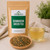 Bulk Genmaicha Green Tea in The Tea Hut kraft pouch, with loose organic green tea and roasted brown rice beside a clear golden-green brewed cup.